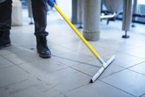 Dry mopping the floor before cleaning