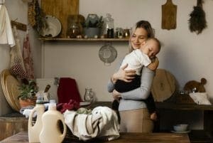 mother holding baby after safe eco cleaning