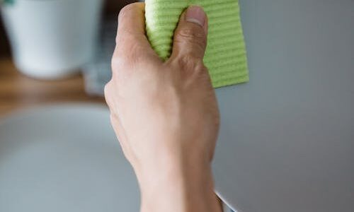 Eco-friendly reusable cleaning cloth used to wipe a plate – sustainable kitchen alternative to paper towels